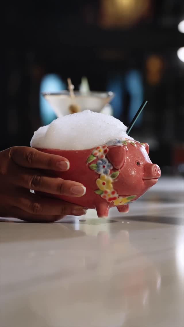 Pink ceramic pig mug filled with foam