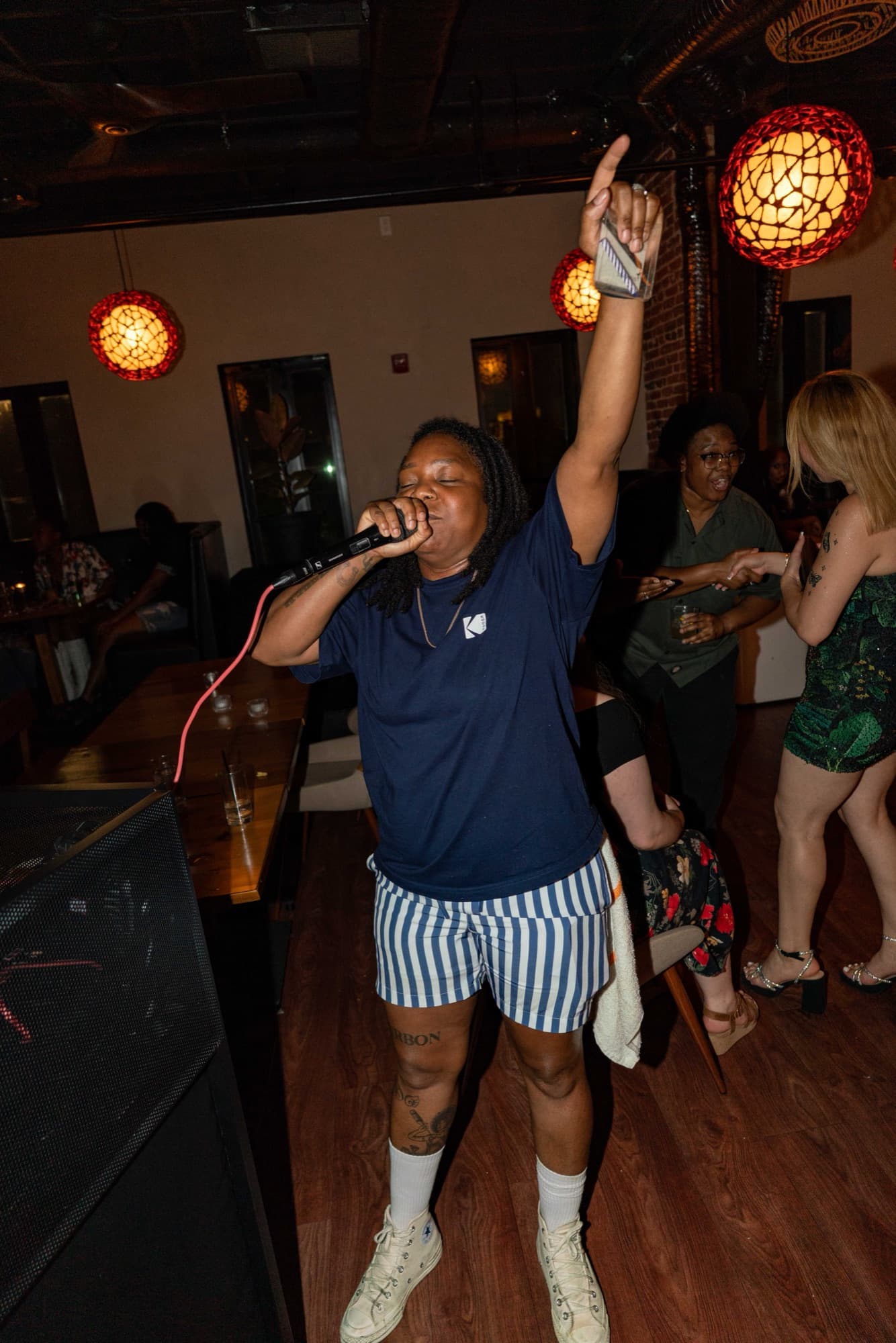 A guest on the mic, arm to the ceiling