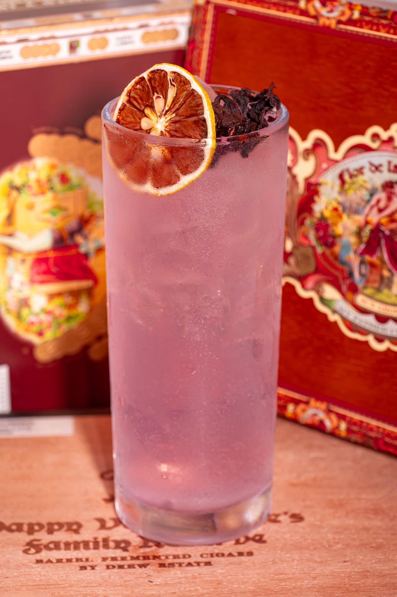 A lavender highball crowned with hibiscus